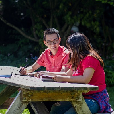Students sitting at a picnic bench