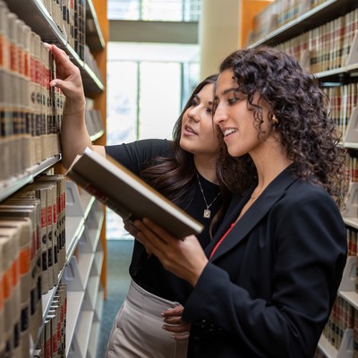 Two women at the Seattle University Law Library browsing law books