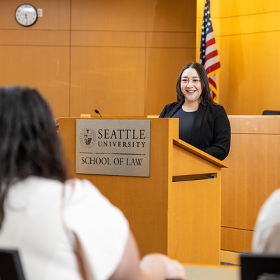 A student speaking at a podium