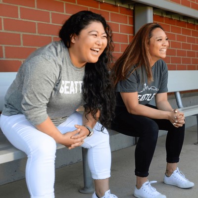 Two women sitting on a bench.
