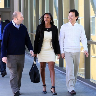 A group of people walking down a walkway.