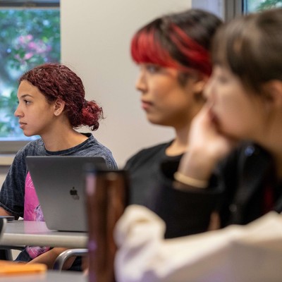 A group of people sitting at desks.