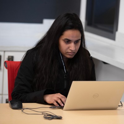 Graduate computer science student studies in the computer science study area located on the first floor of the Sinegal Center