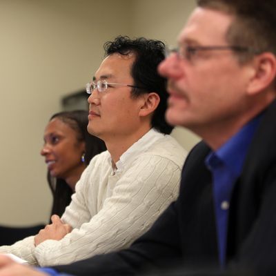 Three grad students in profile in class