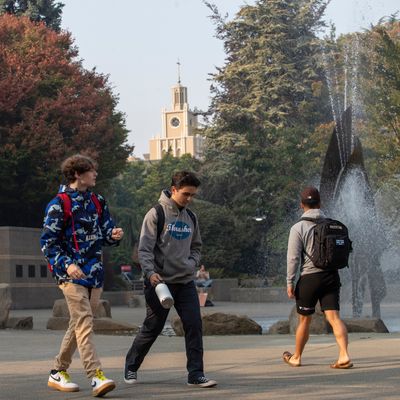 two students walking across the Quad, iconic Administration building in the backgroud