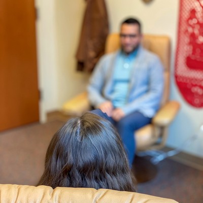 Over the shoulder view of an unidentifiable student receiving counseling.