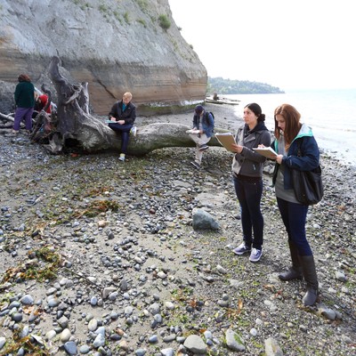 students observing and taking notes at Discovery Park for geology class