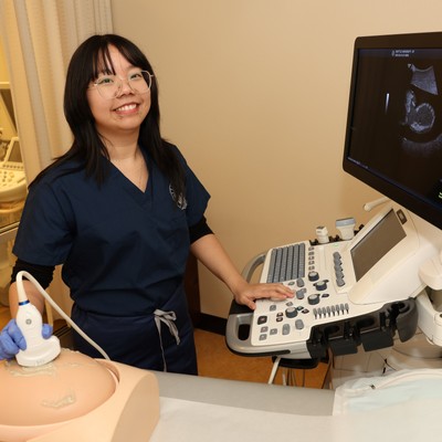 Student doing an ultrasound in a clinical setting