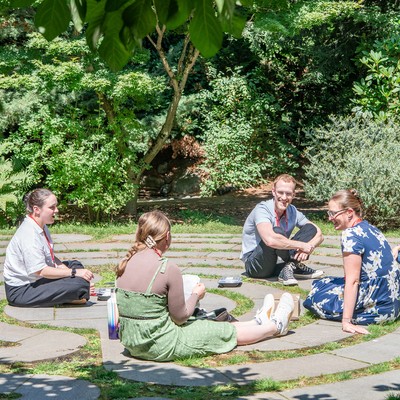 Several students sitting outside in nature