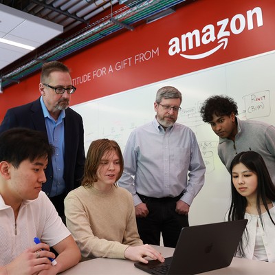 Students with professors with the Amazon logo in the background
