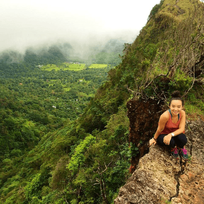 Student sitting on mountainside
