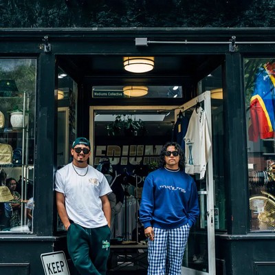 Two men standing outside a store front