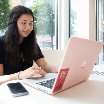 Student sitting in cafe with computer