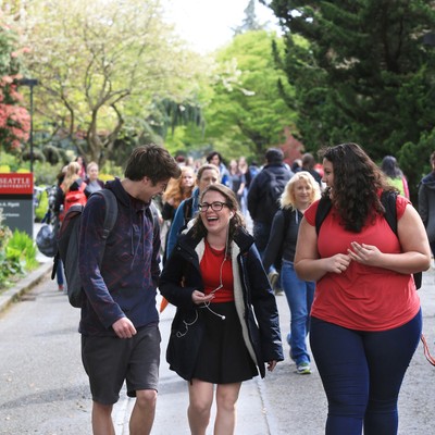 Group of laughing students walking on campus