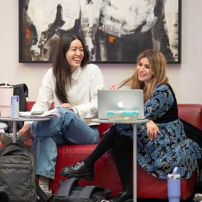 two students with laptops