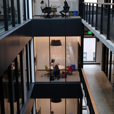 The atrium of an office building with glass walls.