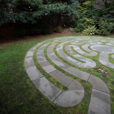 A circular stone labyrinth in a garden.