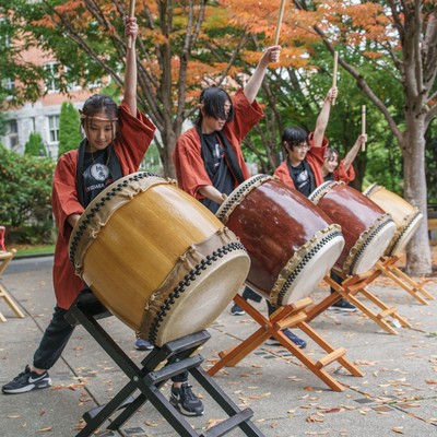 A group of people playing drums.
