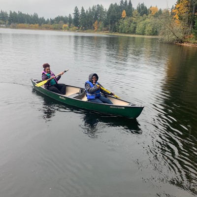 Two students paddling a kayak on the lake