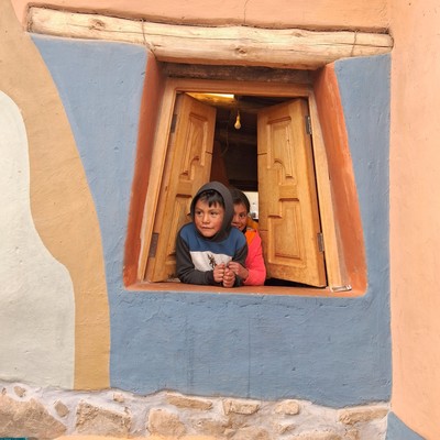 two children looking out a window