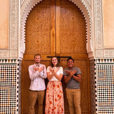 Three Students Stand in Doorway in Morocco