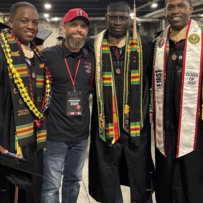 A group of grads standing together.