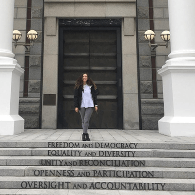 Student in front of courthouse with text on the steps