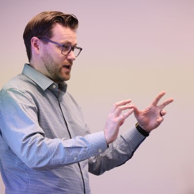 Professor teaches in front of a whiteboard