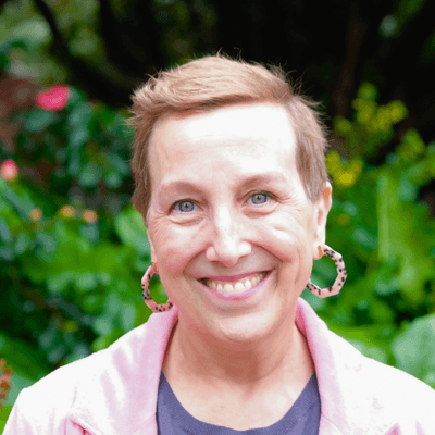 a woman in front of a tree