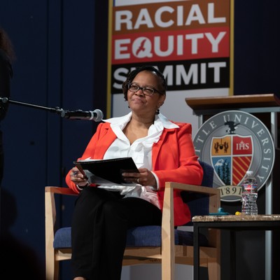 Vice President Natasha Martin sitting in a chair on a stage at an event.