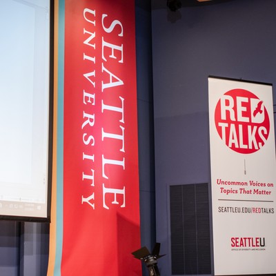 Picture of stage with banner that says Red Talks.