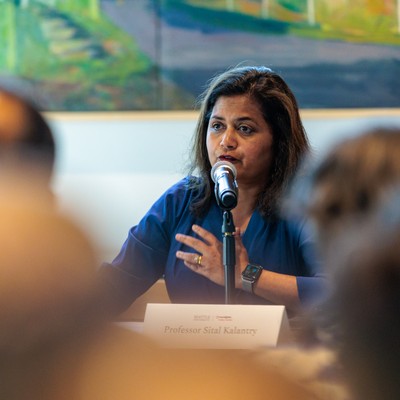 Director Sital Kalantry speaking at microphone