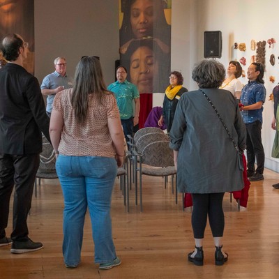 Students and faculty gather in circle