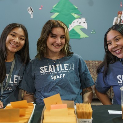 Three staff members ready to check in students