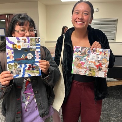 Two students holding up their boards