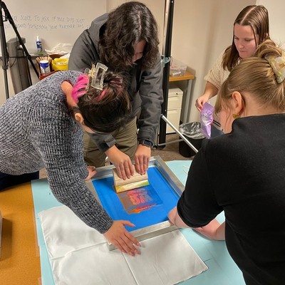 Students screen printing posters