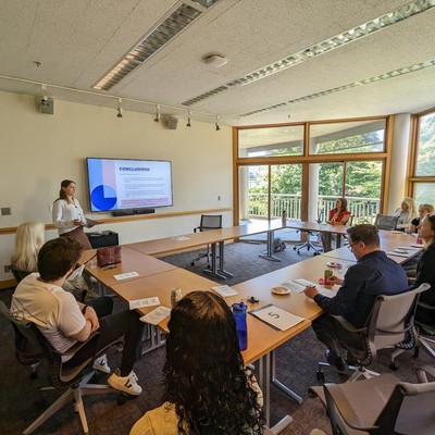 A large panel of students learning from a presentation
