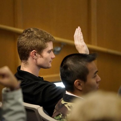 Student raising hand in class