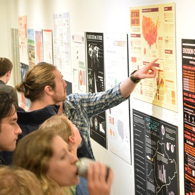 Student viewing posters on a wall