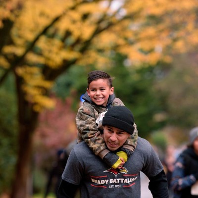Photo with a student and their young son running