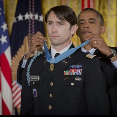 President Obama giving an SU veteran student the medal of honor