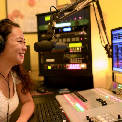 Student hosting a radio program on KXSU