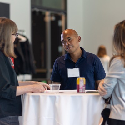 Mentor talking with students at a reception
