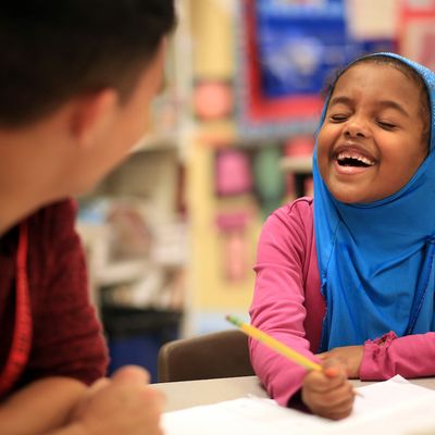 School pupil enjoying a lesson with a Seattle University student