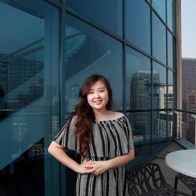 Phoebe Kim standing in front of office windows