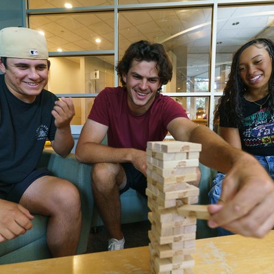 3 students playing Jenga Campion lobby