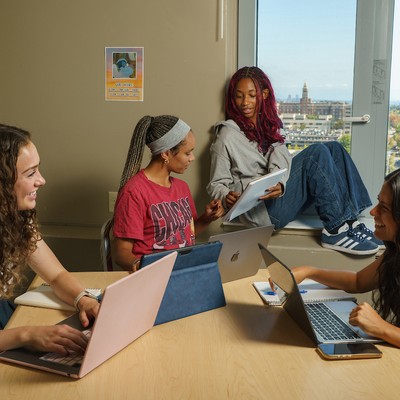 4 students in study space with laptops