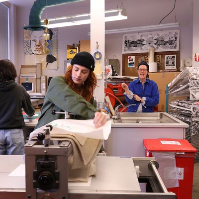 Students and professor working in print studio