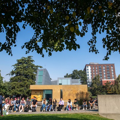 Students sitting by the chapel