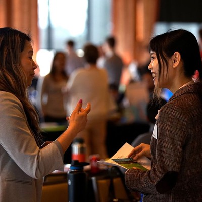 Photo of prospective employer and student in conversation at a career-related event